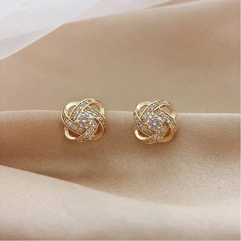 Golden spiral earrings with crystals