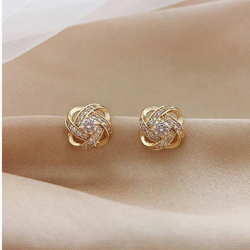 Golden spiral earrings with crystals