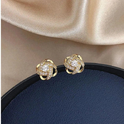 Golden spiral earrings with crystals