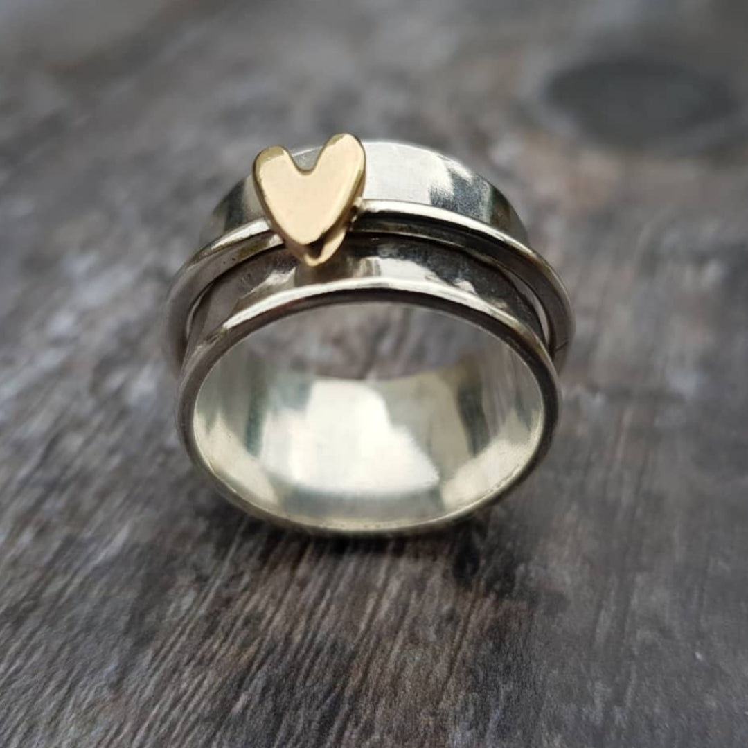 Silver ring with golden heart