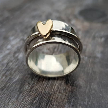 Silver ring with golden heart