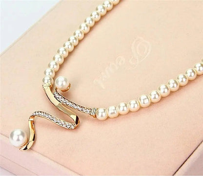 Set of a necklace and earrings with natural pearls