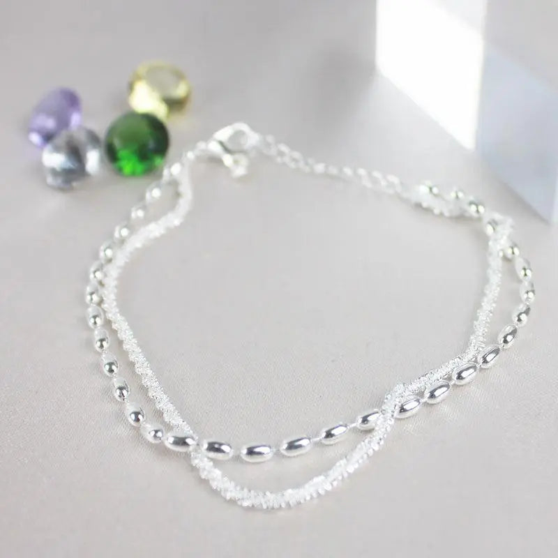 Elegant silver bracelet set with zirconium stones