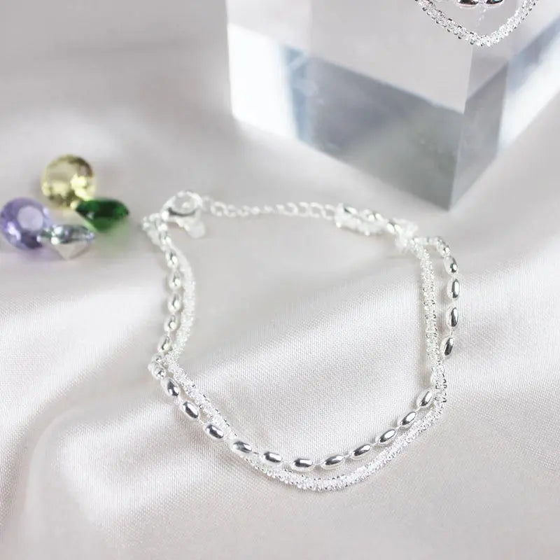 Elegant silver bracelet set with zirconium stones